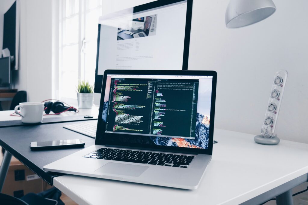 SEO learning workspace with a laptop displaying code while documenting real learning progress.